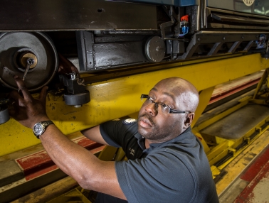 Craig Smith prepares to change out a load wheel on the subway to the Hart and Dirksen Buildings in the Hart Maintenance Station. The subway staff performs monthly preventive maintenance checks to detect wear and replace the wheels, as needed.