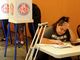 Michelle Pena, 23, seats down at near by table to vote