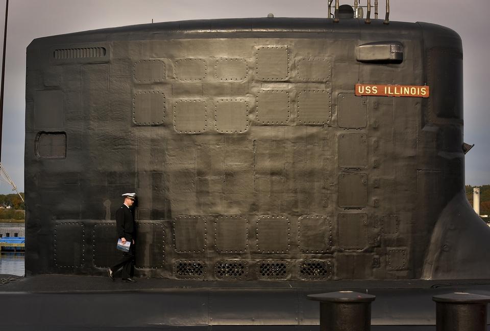 A crew member of the newest Virginia-class, fast attack submarine USS Illinois (SSN 786) walks along the deck prior to the commissioning ceremony for the submarine on the waterfront at the U.S. Naval Submarine Base in Groton on Saturday, Oct. 29, 2016.   (Tim Cook/The Day)