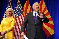 Sen. John McCain, R-Ariz. waves to supporters at his victory party as wife Cindy McCain joins him on stage as he announces his victory over Democratic challenger Rep. Ann Kirkpatrick Nov. 8, 2016, in Phoenix. (AP Photo/Ross D. Franklin)