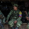 Members of the Revolutionary Armed Forces of Colombia, or FARC, rest in a window of a store in a small village in the mountains of Colombia in March, 2016. Colombia’s government and FARC, the largest rebel group in the country, have reached a deal to end more than 50 years of conflict, the two sides announced on Aug. 24, paving the way for an end to the longest running war in the Americas.
