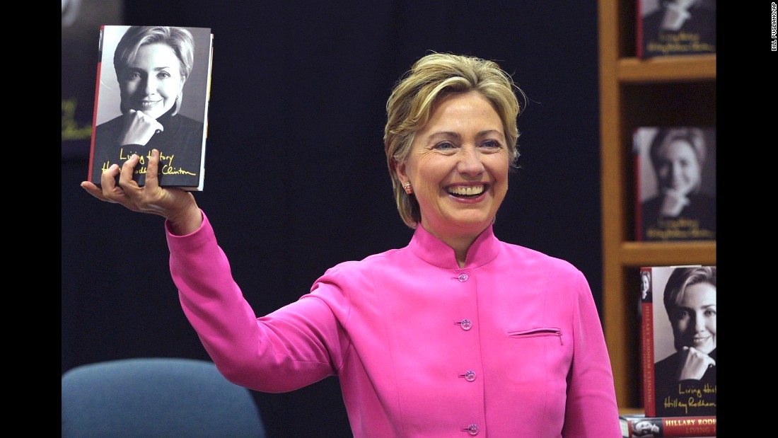 Clinton holds up her book &quot;Living History&quot; before a signing in Auburn Hills, Michigan, in 2003.