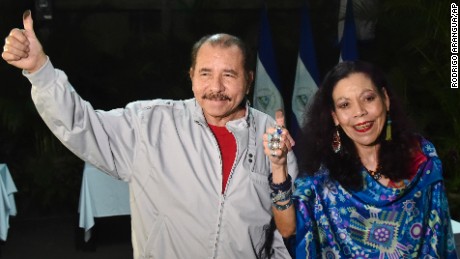 Nicaragua&#39;s President Daniel Ortega and his wife, vice presidential candidate Rosario Murillo show their marked thumbs after voting at a polling station near a his home in Managua, Nicaragua, Sunday, Nov. 6, 2016. Ortega appears headed for a a third consecutive term victory in the general election, but critics accused Ortega and his allies of manipulating the political system to guarantee he stays in power by dominating all branches of government. (Rodrigo Arangua/Pool via AP)