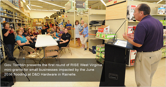 Gov. Tomblin presents the first round of RISE West Virginia mini grants for small businesses impacted by the June 2016 flooding at DD Hardware in Rainelle.