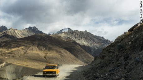 Old Car Driving Pamir Highway: The road turns into rough, and at times dangerous dirt and gravel, when entering the Wakhan Corridor.