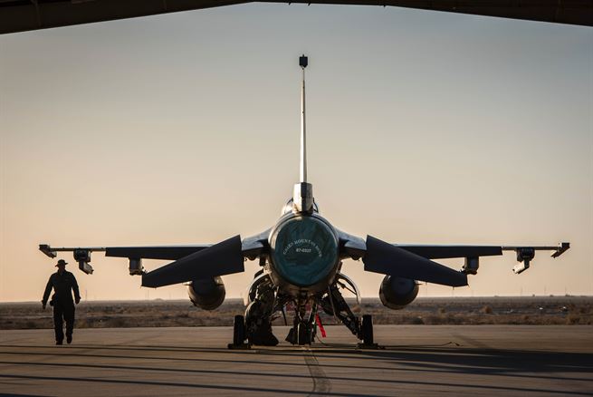 A crew chief with the 407th Expeditionary Aircraft Maintenance Squadron walks past an F-16 Fighting Falcon assigned to the 134th Expeditionary Fighter Squadron at the 407th Air Expeditionary Group, Southwest Asia, Dec. 10, 2016. About 300 Airmen from the 158th Fighter Wing of the Vermont Air National Guard comprise the units. (U.S. Air Force photo by Master Sgt. Benjamin Wilson)(Released)