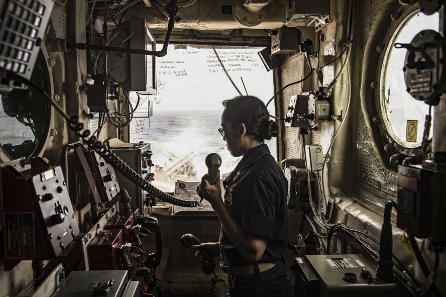 Navy Lt. j.g. Catherine Miller stands watch inside the helicopter control tower on the USS San Jacinto.