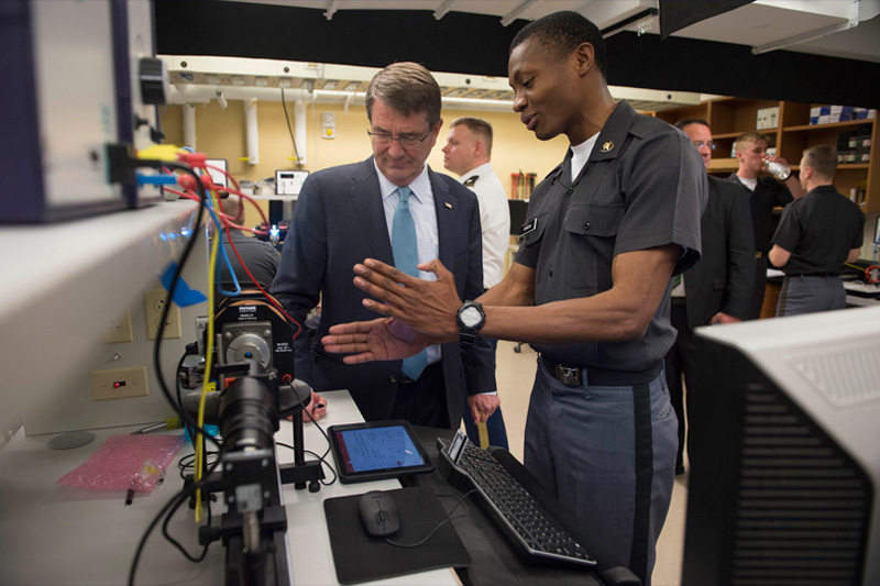 Photo of Defense Secretary Ash Carter reviewing the principles of physics with cadets.