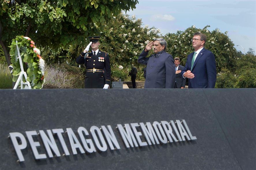 Defense Secretary Ash Carter, right, and Indian Defense Minister Manohar Parrikar render honors after laying a wreath at the 9/11 Pentagon Memorial.
