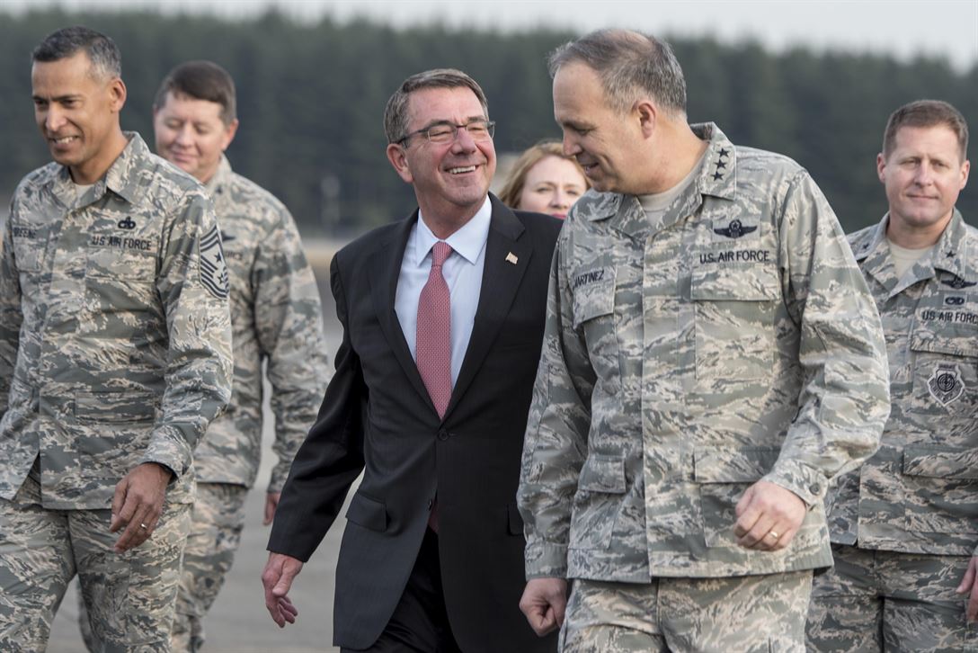 Defense Secretary Ash Carter speaks with Air Force Lt. Gen. Jerry Martinez, commander of U.S. Forces Japan and 5th Air Force, after arriving at Yokota Air Base, Japan.