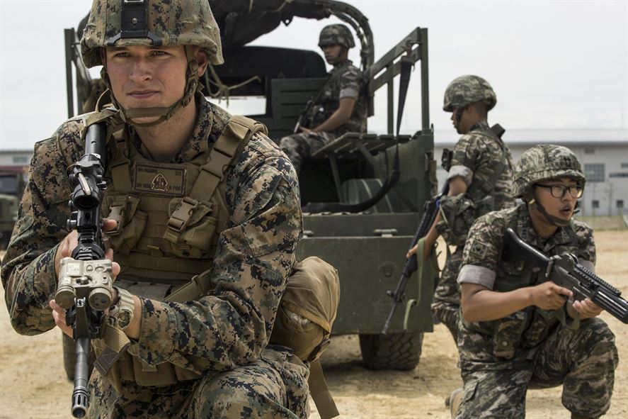 Marine Corps Cpl. Beau M. Higgins posts security beside a South Korean marine.