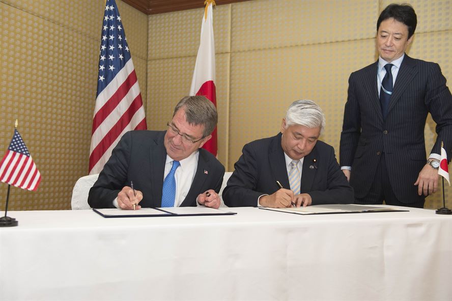 Defense Secretary Ash Carter signs a reciprocal defense agreement with Japanese Defense Minister Gen Nakatani,