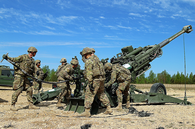 Soldiers conducting simulated artillery fire missions.
