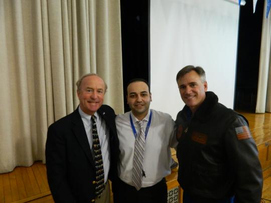 Principal Carlos Gramata, Congressman Rodney Frelinghuysen and CMDR Carl Newman pause before Newman, a NOAA pilot, tells students at Beatrice Gilmore School in Woodland Park of his experiences as a 