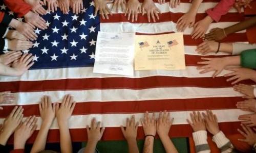 Elementary school students pose with a letter sent by Congressman Hunter in response to their comments and questions about the issues facing their generation feature image