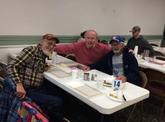 Rodney eats breakfast with volunteers at the Ironia Fire Dept,