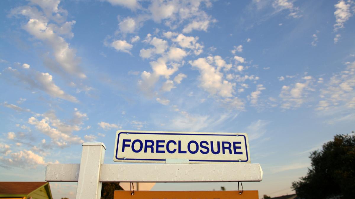 foreclosure sign in front of a house