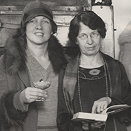 Two Women Holding a Cookbook and a Dessert