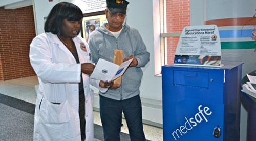 Doctor helping a veteran dispose of unused medication