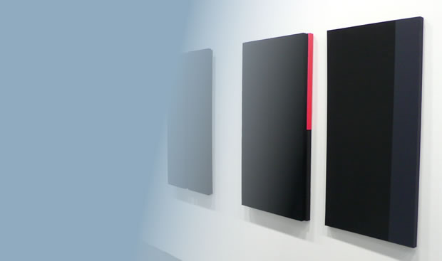 Balck canvases on a wall.