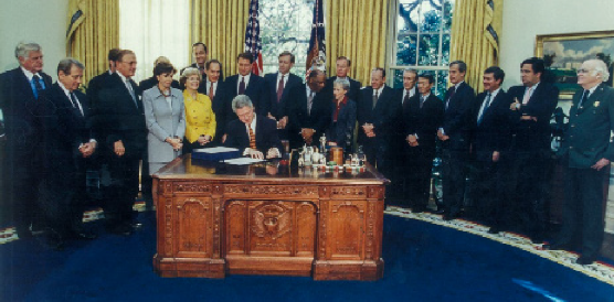 Nancy Pelosi with President Clinton as he signs the Presidio Trust Act in November 1996