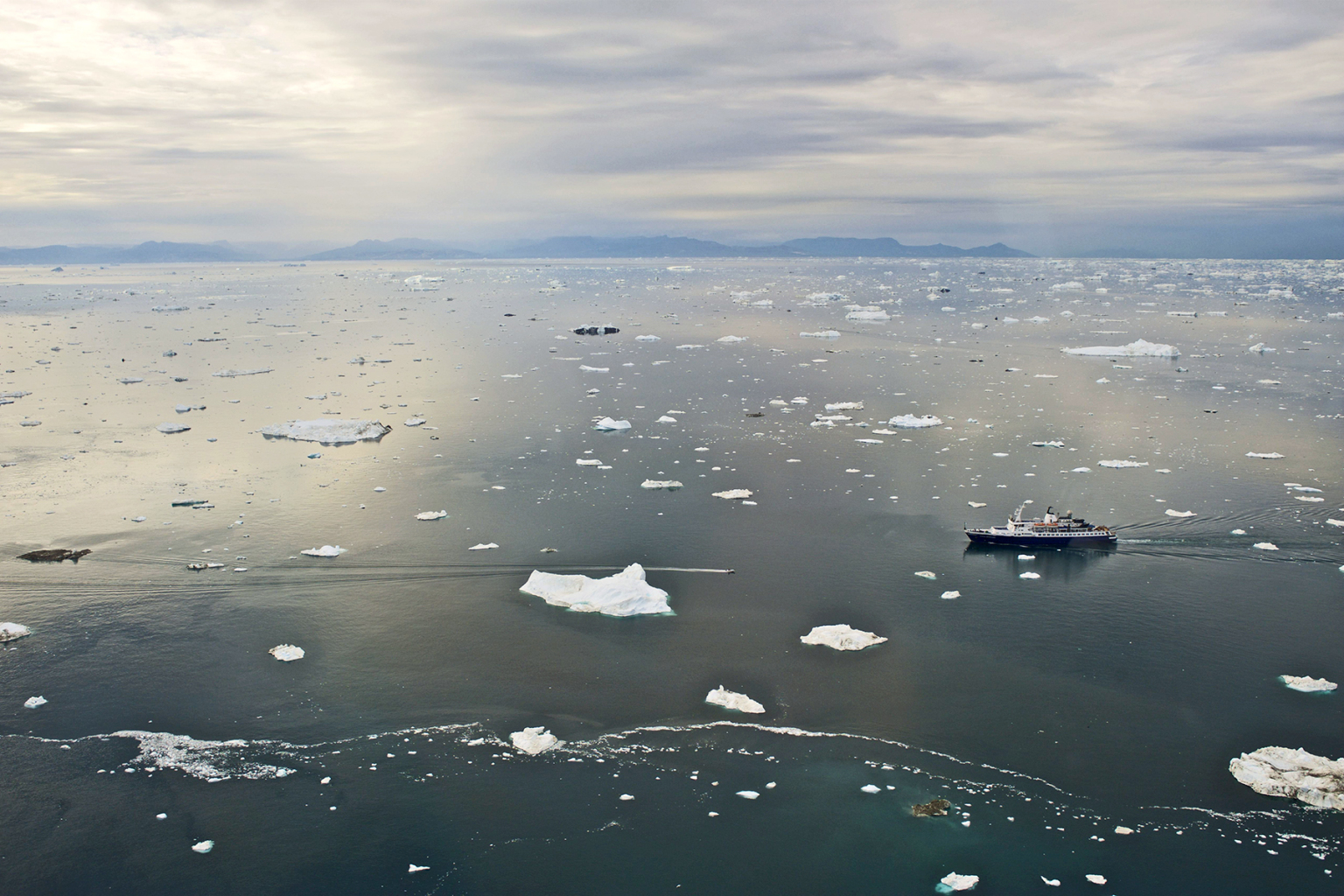 A cruise ship near the harbor of Ilulissat off the west coast of Greenland, north of the Arctic Circle, in August 2012. (Education Images/UIG via Getty Images)