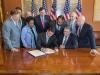 House Members watch Paul Ryan sign the bipartisan aid bill