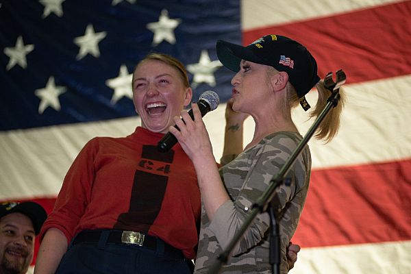 Country music artist Kellie Pickler and a Sailor perform a song together during a USO tour performance in the hangar bay aboard the aircraft carrier USS John C. Stennis (CVN 74). The John C. Stennis Carrier Strike Group is deployed to the U.S. 5th Fleet area of operations in support of naval operations to ensure maritime stability and security in the Central Region, connecting the Mediterranean and the Pacific through the western Indian Ocean and three strategic choke points.  U.S. Navy photo by Mass Communication Specialist Seaman Mitchell Banks (Released)  181223-N-HX510-0159