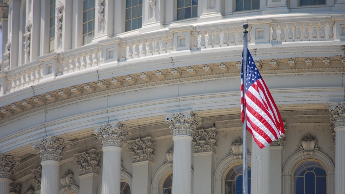 The American Flag flies proud in front of the U.S. Capitol dome.