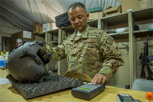 Senior Master Sgt. Vincent Aldama inspects an HGU-56/P aircrew flight helmet March 8, 2013, on Camp Bastion, Afghanistan. Aldama is responsible for flight equipment such as helmets, oxygen masks, parachutes, flotation devices, survival kits, night vision goggles, anti-G garments, aircrew eye and respiratory protective equipment and other types of aircrew flight equipment. Aldama is an aircrew flight equipment specialist deployed to the 26th Expeditionary Rescue Squadron. (U.S. Air Force photo/Tech. Sgt. Dennis J. Henry Jr.)