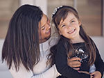 An African-American women with her Caucasian foster daughter. 