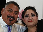 A Hispanic man and women smiling at the camera. 
