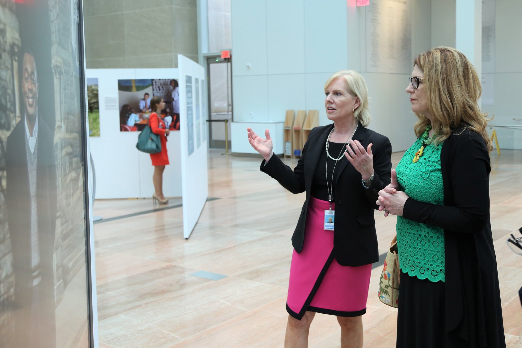 Director Mary Kane demonstrates Faces of Diplomacy exhibit with the board