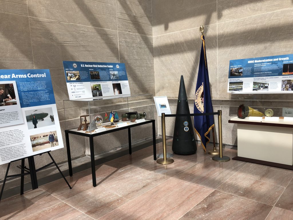Diplomacy Center exhibit cases of Nuclear Arms including flags, artifacts, and information