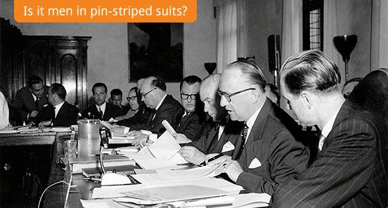 Is it men in pin-striped suits? (The German delegation at their table studying documents in the conference hall during the session on the Euratom agreements in Venice, Italy, May 29, 1956. (AP Photo/Raoul Fornezza))
