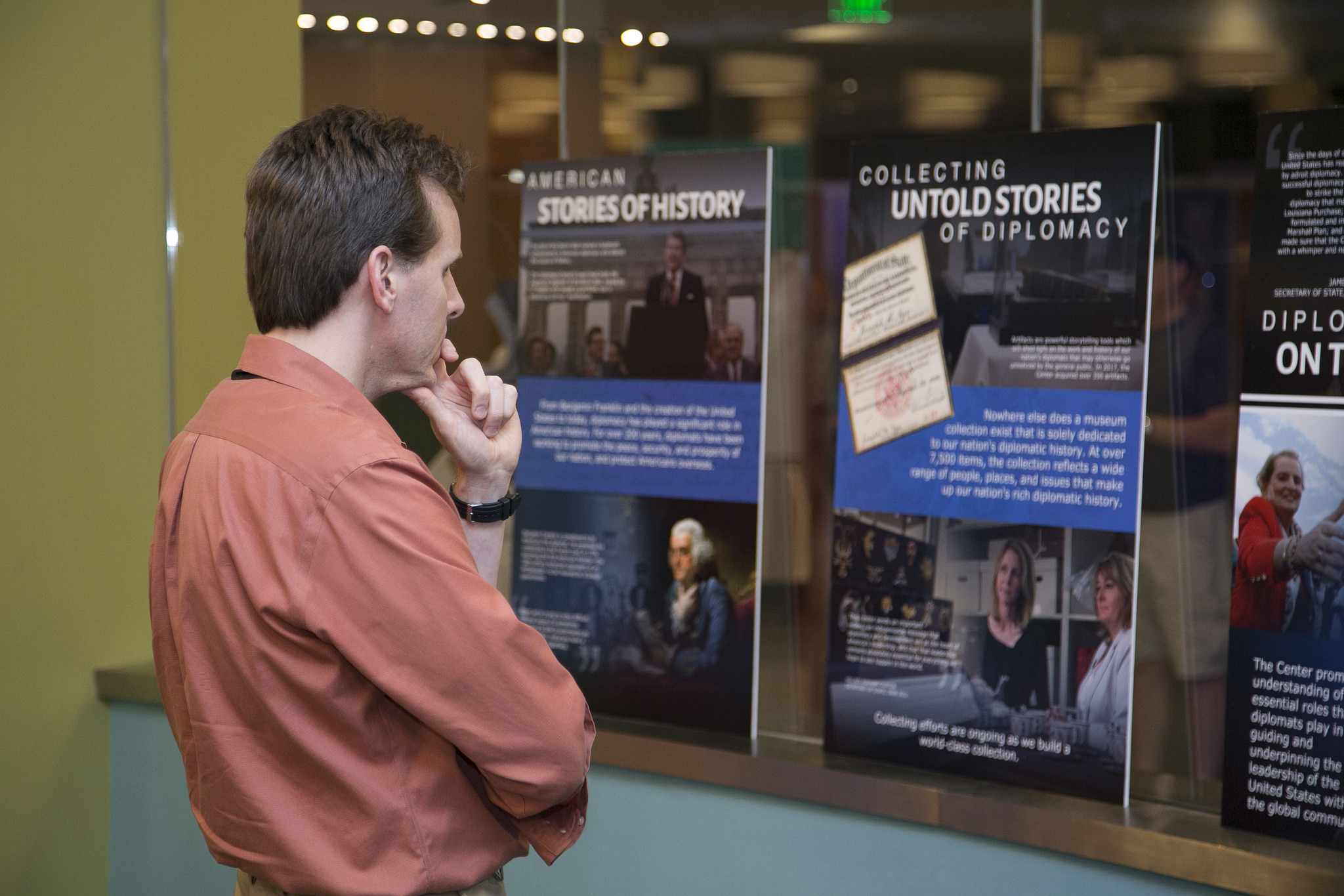 A man observes the posters of the Diplomacy Center