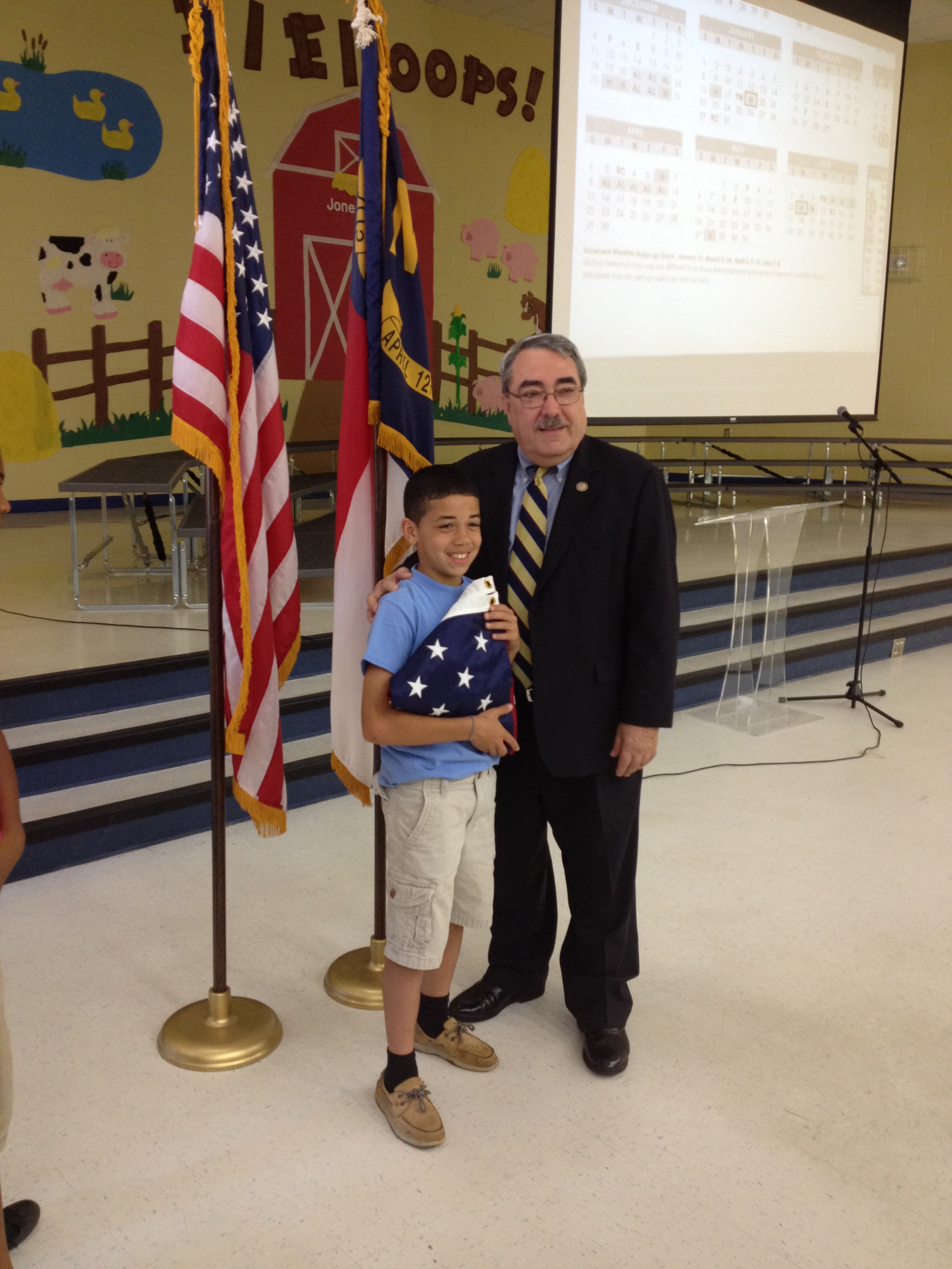 Congressman Butterfield presents a flag to a student at Jones Elementary in Wilson
