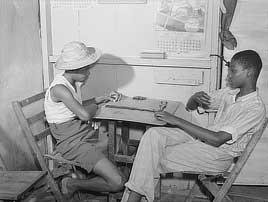 Charlotte Amalie, Saint Thomas Island, Virgin Islands. Playing dominoes in a small candy store. Film negative by Jack Delano, 1941. Prints & Photographs Division