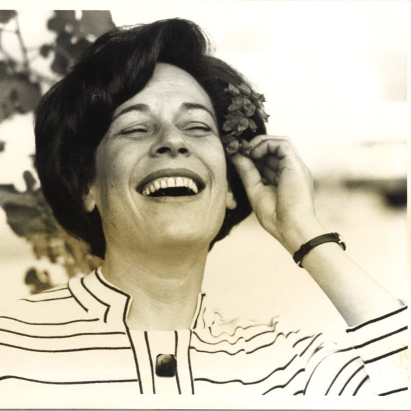 Portrait of Lois Roth with flower