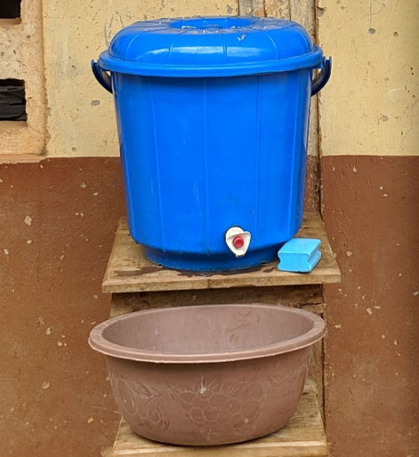 hand washing using a water canister and basin
