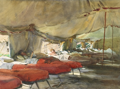 Men in cots in a tent