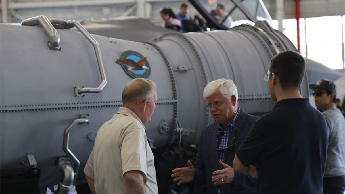 Rep. Larson speaks with engineers while viewing the F135 engine mock-up.