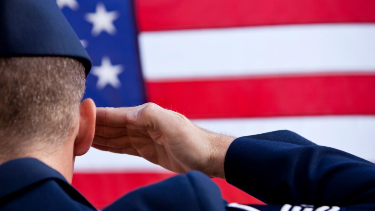 soldier saluting the US flag