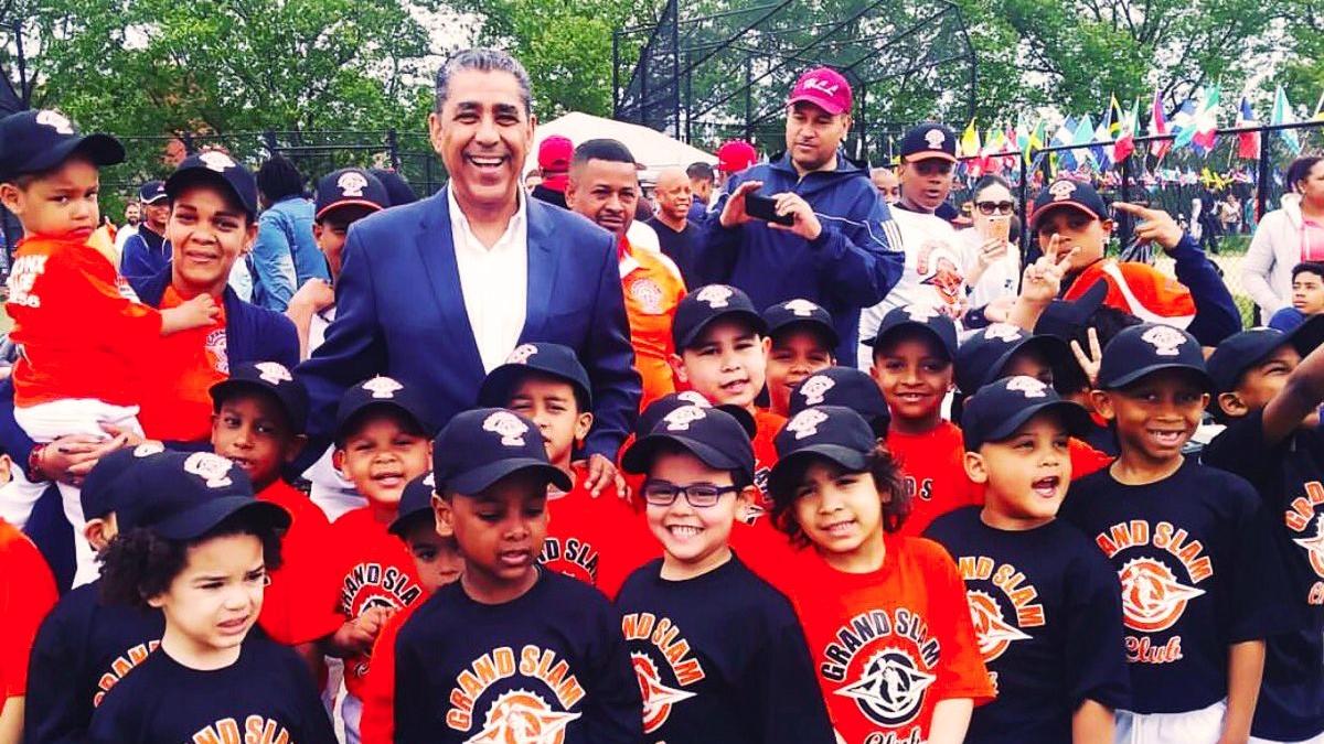 Congressman Espaillat posing with a group of youth from the Grand Slam Club
