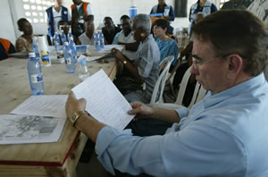 Photograph of Secretary Thompson attending a briefing in Haiti