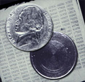 Photograph of hollow nickel and message it contained.