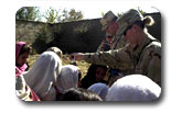 This is a male and female soldier handing out crayons and books to kids. Some photographs were obtained from www.dod.gov; remember.gov; and www.whitehouse.gov