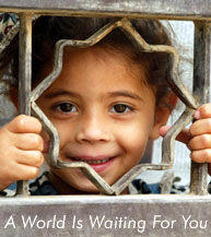 Photo: Picture of a young girl peering out from her patio.  Text under picture reads 'A World Is Waiting For You'