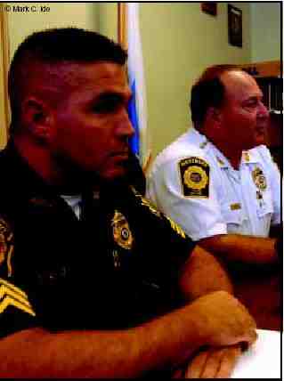 Photograph of two police officers at a meeting