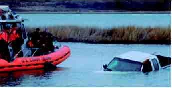 Photograph of Sheriff's Office Emergency Response Team approaching kidnap suspect in his submerged pick-up truck